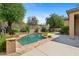 Inviting pool featuring natural rock accents and lush landscaping for a private, tranquil retreat at 15037 N 114Th Way, Scottsdale, AZ 85255