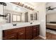 Bright main bathroom featuring a dual sink vanity and large mirrors with decorative lighting at 1617 W Pecan Rd, Phoenix, AZ 85041
