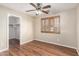 This bedroom features wood floors, a window with plantation shutters, and a closet at 1617 W Pecan Rd, Phoenix, AZ 85041