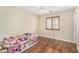 Bright bedroom with wood floors, ceiling fan, and a window with wooden shutters at 1617 W Pecan Rd, Phoenix, AZ 85041