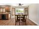 Bright dining area boasts wood flooring and a large window with shutters overlooking the pool at 1617 W Pecan Rd, Phoenix, AZ 85041
