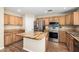 Well-lit kitchen featuring stainless steel appliances, a center island with butcher block countertop and wood cabinets at 1617 W Pecan Rd, Phoenix, AZ 85041