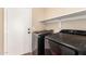 Laundry room with a washer, dryer, and shelving at 1617 W Pecan Rd, Phoenix, AZ 85041