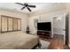 Comfortable main bedroom with wood floors, ceiling fan, shutters and access to the ensuite bathroom at 1617 W Pecan Rd, Phoenix, AZ 85041