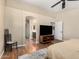Comfortable main bedroom featuring wood floors, ceiling fan and access to the ensuite bathroom at 1617 W Pecan Rd, Phoenix, AZ 85041