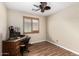 Office with wood floors, ceiling fan, and a window with wooden shutters at 1617 W Pecan Rd, Phoenix, AZ 85041