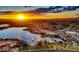 Stunning aerial view of the community lake with multiple fountains, palm trees and beautiful scenery at 16551 W Desert Ln, Goodyear, AZ 85338