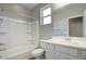Bathroom featuring a shower-tub combo, single sink vanity, and framed mirror at 16551 W Desert Ln, Goodyear, AZ 85338