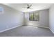 Spacious bedroom featuring soft carpet, neutral walls, and a modern ceiling fan at 16551 W Desert Ln, Goodyear, AZ 85338