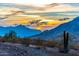 Scenic desert landscape view with mountains and a vibrant sunset, showcasing the natural beauty of the area at 16551 W Desert Ln, Goodyear, AZ 85338