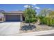 Charming single-story home with a well-maintained front yard and a two-car garage at 16551 W Desert Ln, Goodyear, AZ 85338