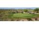Picturesque golf course with green, golf carts, and scenic views of the desert landscape at 16551 W Desert Ln, Goodyear, AZ 85338