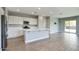 Modern kitchen features a center island, stainless appliances, white cabinetry, and an open-concept layout at 16551 W Desert Ln, Goodyear, AZ 85338