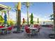 Outdoor patio with comfortable seating, umbrellas, and a scenic view of the lake and community at 16551 W Desert Ln, Goodyear, AZ 85338