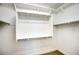 Walk-in closet featuring custom shelving and hanging racks at 16551 W Desert Ln, Goodyear, AZ 85338