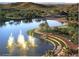 Attractive water feature with lake, fountains, palm trees, and manicured landscaping at 16551 W Desert Ln, Goodyear, AZ 85338
