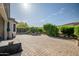 Expansive backyard showcasing lush landscaping, a paved patio, and meticulous greenery at 17520 W Fairview St, Goodyear, AZ 85338
