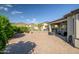 Spacious brick-paved backyard with covered patio, lush landscaping, and mountain views at 17520 W Fairview St, Goodyear, AZ 85338