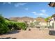 Wide backyard view showcasing lush greenery, desert landscaping, and mountain views at 17520 W Fairview St, Goodyear, AZ 85338