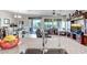 Open floor plan with kitchen island leading to a living room with large windows and neutral decor at 17520 W Fairview St, Goodyear, AZ 85338