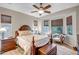 Serene main bedroom featuring a comfortable bed, ample natural light, and a cozy seating area for relaxation at 17520 W Fairview St, Goodyear, AZ 85338