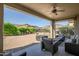 Cozy covered patio area with comfortable seating and views of the manicured backyard at 17520 W Fairview St, Goodyear, AZ 85338