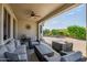 Spacious covered patio featuring ample seating and a view of the expansive backyard at 17520 W Fairview St, Goodyear, AZ 85338