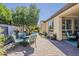 Inviting backyard patio with outdoor seating, well-maintained landscaping, and a charming pergola at 1776 E Laddoos Ave, Queen Creek, AZ 85140