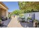 Relaxing backyard featuring pavers, outdoor kitchen, privacy fence and mature landscaping at 1776 E Laddoos Ave, Queen Creek, AZ 85140
