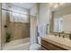 Bathroom with tub-shower combination, decorative tile accents, and a vanity with sink and countertop at 1776 E Laddoos Ave, Queen Creek, AZ 85140