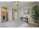 Well-lit bedroom featuring stylish furnishings, serene decor, and an open doorway to the en-suite bathroom at 1776 E Laddoos Ave, Queen Creek, AZ 85140