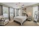 Bright and airy bedroom featuring neutral tones, large windows and ceiling fan at 1776 E Laddoos Ave, Queen Creek, AZ 85140