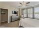 Bright bedroom with neutral tones, lots of windows, and a stylish dresser and television at 1776 E Laddoos Ave, Queen Creek, AZ 85140