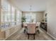 Elegant dining room with a wooden table, upholstered chairs, shuttered windows, and stylish light fixture at 1776 E Laddoos Ave, Queen Creek, AZ 85140