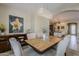 An elegant dining room showcases a wood table, upholstered chairs, a chandelier, and tasteful decor at 1776 E Laddoos Ave, Queen Creek, AZ 85140