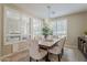 Bright dining room with ample natural light, a rustic table, and elegant upholstered chairs at 1776 E Laddoos Ave, Queen Creek, AZ 85140