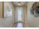 Welcoming entryway with stylish tile flooring, a decorative light fixture, and elegant wall art at 1776 E Laddoos Ave, Queen Creek, AZ 85140