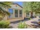Home exterior features professionally landscaped yard, neutral paint, and large windows, offering bright, natural light at 1776 E Laddoos Ave, Queen Creek, AZ 85140