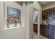 Hallway with decorative art, and a view of the bathroom and built in storage at 1776 E Laddoos Ave, Queen Creek, AZ 85140