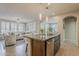 An open layout kitchen features a large island with seating, stainless dishwasher, and ample natural light at 1776 E Laddoos Ave, Queen Creek, AZ 85140