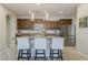 Spacious kitchen with granite countertops, stainless steel appliances, and a large island with barstool seating at 1776 E Laddoos Ave, Queen Creek, AZ 85140