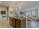 This spacious kitchen boasts a central island with seating and integrates seamlessly with the adjoining living area at 1776 E Laddoos Ave, Queen Creek, AZ 85140