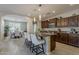 Well-designed kitchen featuring a large island with seating that opens to a dining area with abundant natural light at 1776 E Laddoos Ave, Queen Creek, AZ 85140