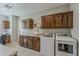 Functional laundry room with built-in cabinets, ample counter space, washer, and dryer at 1776 E Laddoos Ave, Queen Creek, AZ 85140