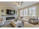 Modern living room with fireplace, comfortable white seating, and lots of natural light at 1776 E Laddoos Ave, Queen Creek, AZ 85140