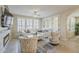 Bright living room with fireplace, white furniture, shuttered windows, and elegant decor at 1776 E Laddoos Ave, Queen Creek, AZ 85140