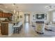 Open-concept living space includes a kitchen island with seating, fireplace and a comfortable seating area at 1776 E Laddoos Ave, Queen Creek, AZ 85140