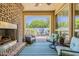 Inviting outdoor patio space with fireplace, lounge seating, and access to the backyard dining area at 1776 E Laddoos Ave, Queen Creek, AZ 85140