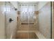 Walk in shower with tile surround, built-in bench, and decorative window at 1776 E Laddoos Ave, Queen Creek, AZ 85140