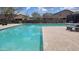 Sparkling community pool with ample seating and lounging areas for residents to enjoy in a relaxing setting at 18224 W La Senda Dr, Surprise, AZ 85387